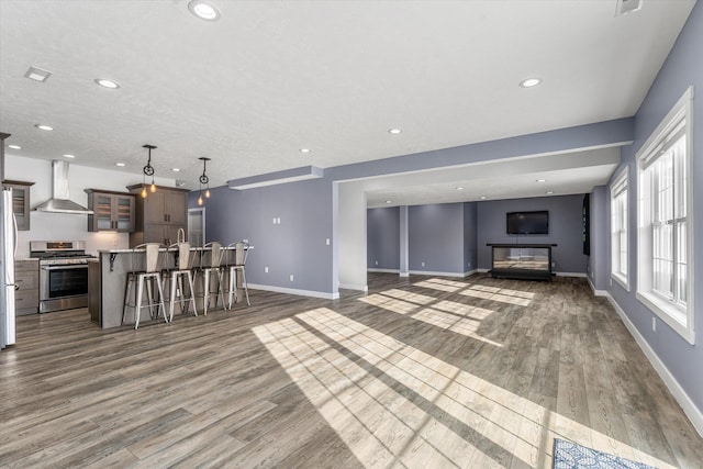 unfurnished living room with dark wood-type flooring and a textured ceiling