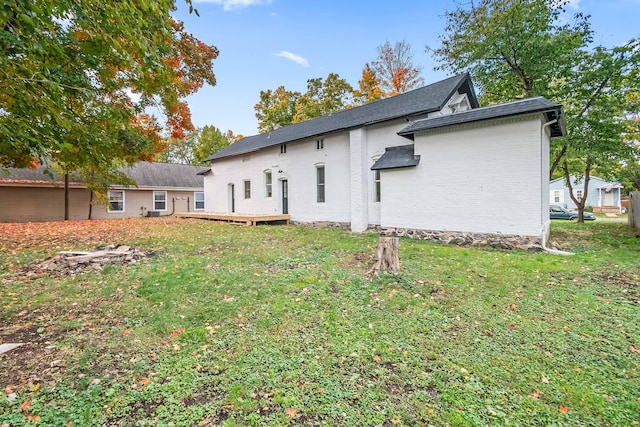 back of house with a lawn