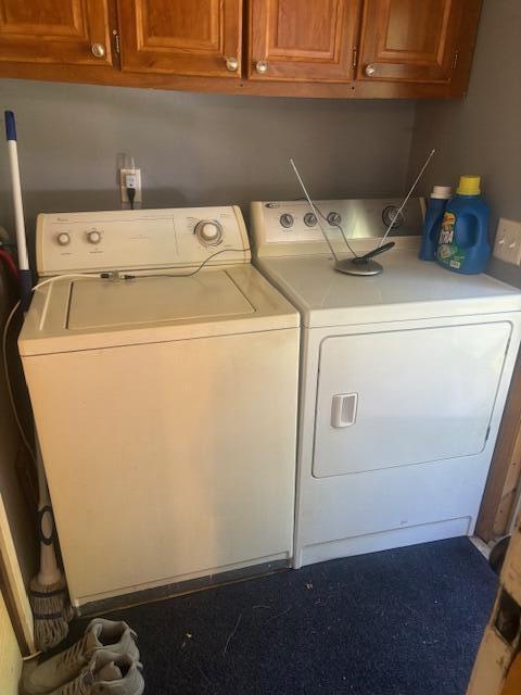 laundry room with cabinets and washing machine and clothes dryer