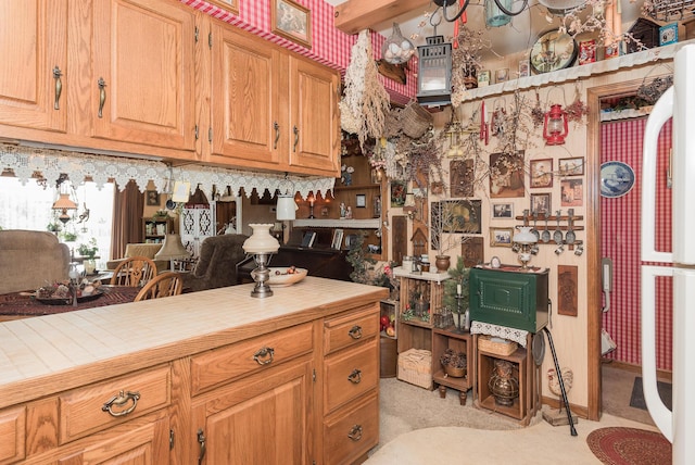 kitchen featuring white fridge and tile countertops