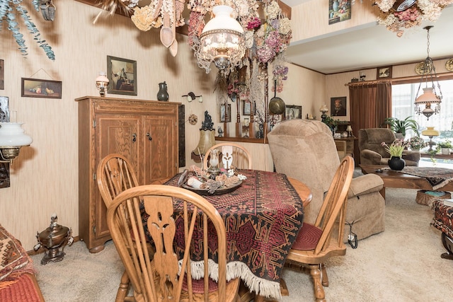 dining room featuring carpet and a chandelier