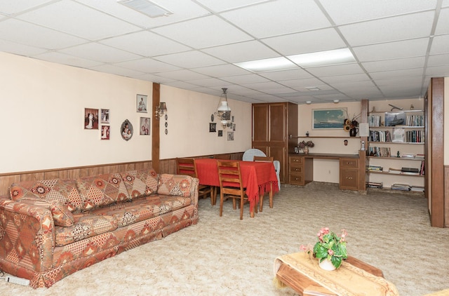 carpeted living room with a paneled ceiling