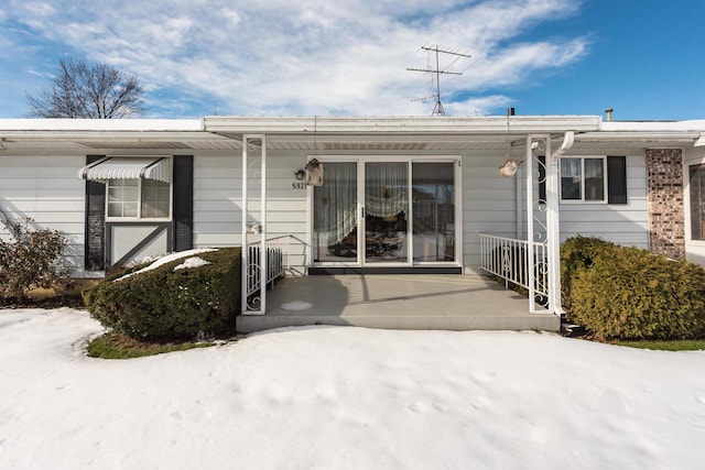 view of exterior entry with a porch