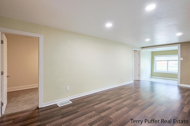 empty room with dark hardwood / wood-style flooring