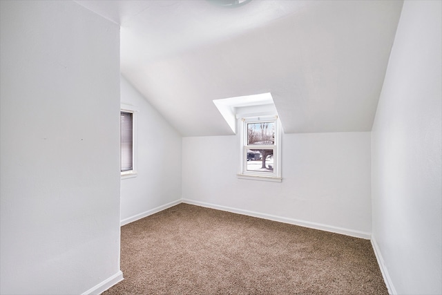 bonus room featuring lofted ceiling and carpet flooring