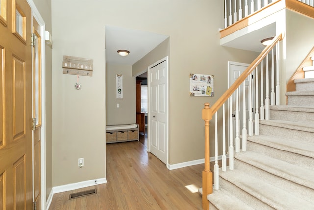 foyer entrance with light hardwood / wood-style floors