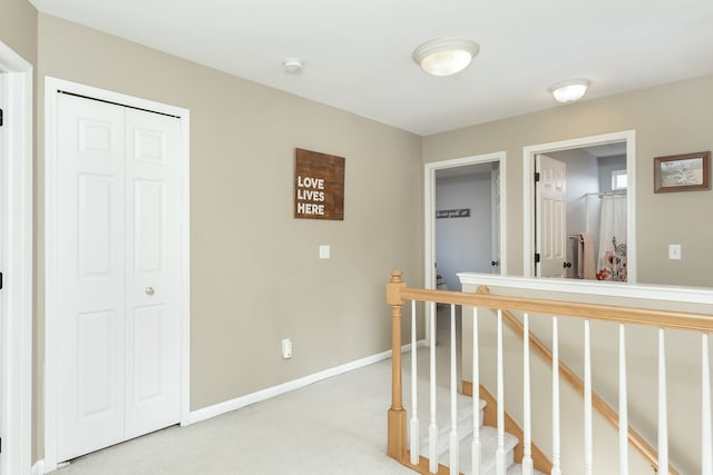 corridor with light colored carpet