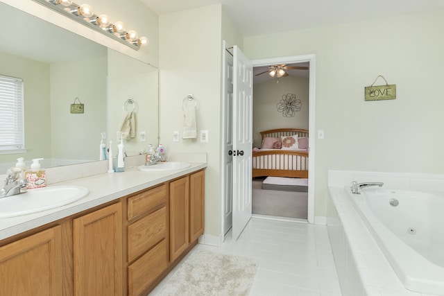 bathroom featuring vanity, tile patterned flooring, and tiled tub