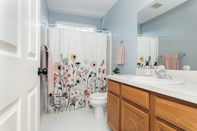 bathroom featuring vanity, toilet, and tile patterned flooring