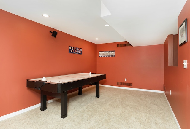 recreation room with light colored carpet