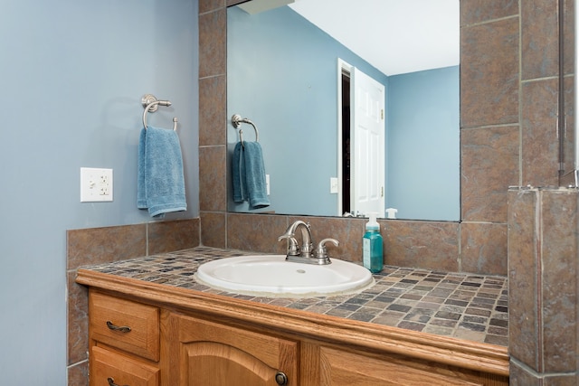 bathroom with vanity and decorative backsplash