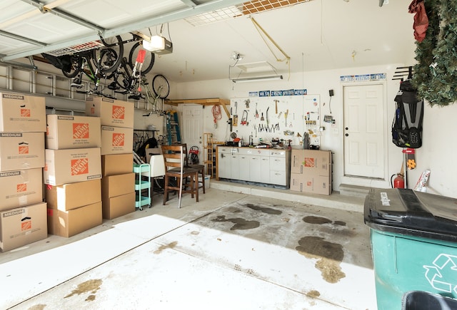 garage with a garage door opener and a workshop area