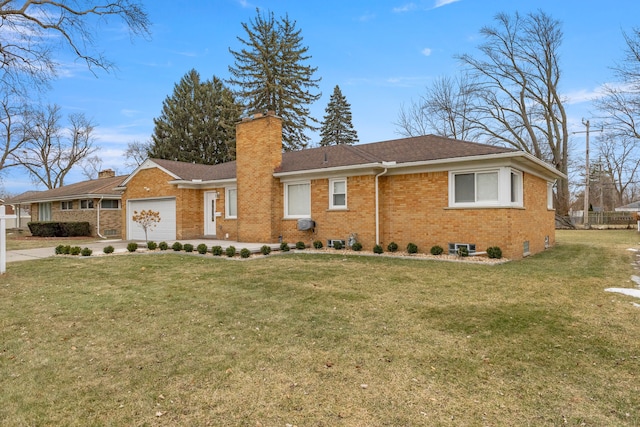 view of front of house with a garage and a front lawn