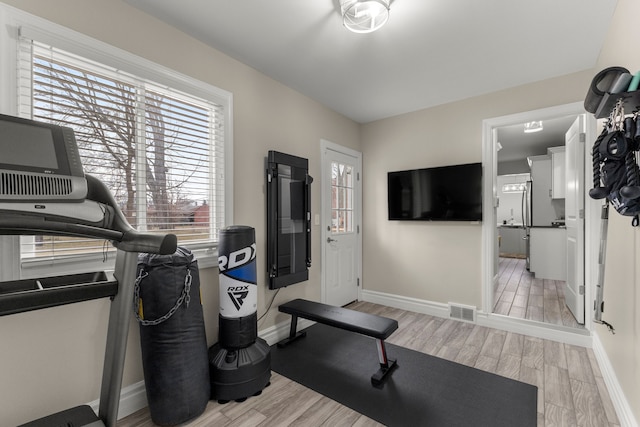 workout area featuring light wood-type flooring