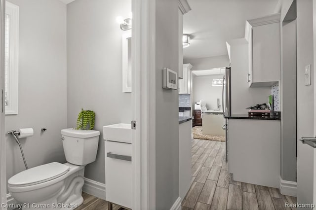 bathroom with tasteful backsplash, vanity, and toilet