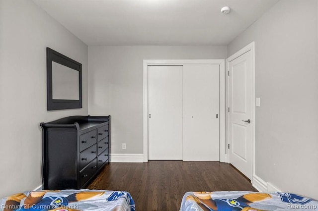 bedroom with a closet and dark hardwood / wood-style floors