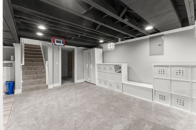 basement featuring electric panel and carpet floors