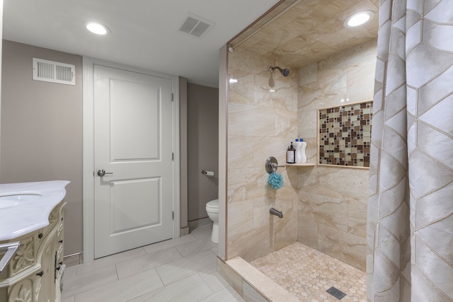 bathroom featuring vanity, toilet, and curtained shower