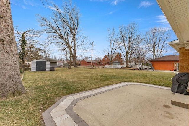 view of yard featuring a storage shed and a patio