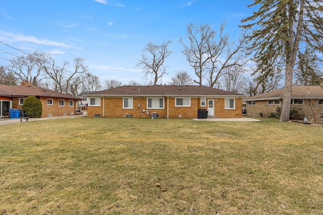 rear view of house featuring a yard and a patio area