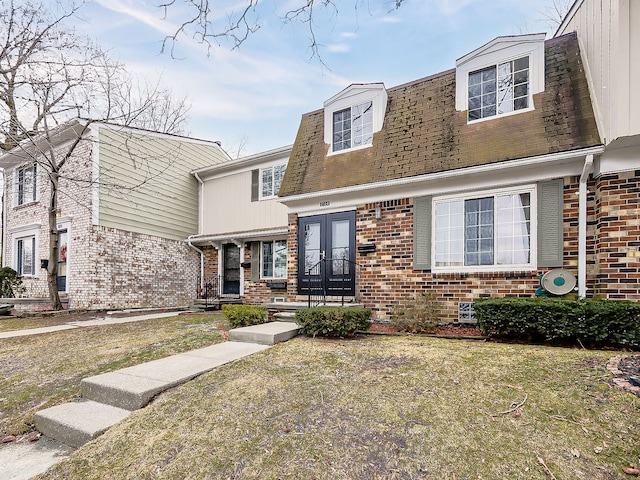 view of front of house featuring a front lawn and french doors