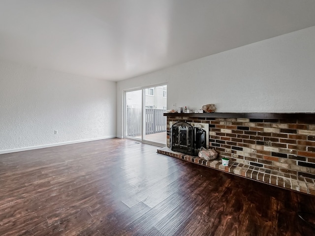 living room featuring wood-type flooring and a fireplace