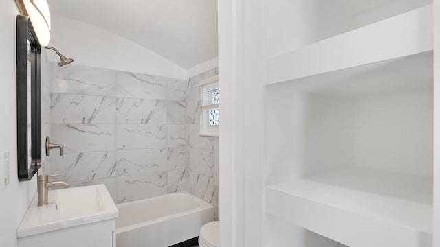 bathroom with lofted ceiling, shower / bath combination, vanity, and toilet