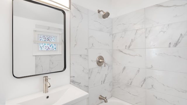 bathroom featuring tub / shower combination and a sink