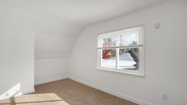 bonus room with carpet, baseboards, and vaulted ceiling