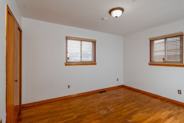 unfurnished bedroom featuring hardwood / wood-style floors and a closet