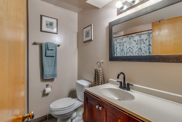 bathroom featuring vanity and toilet