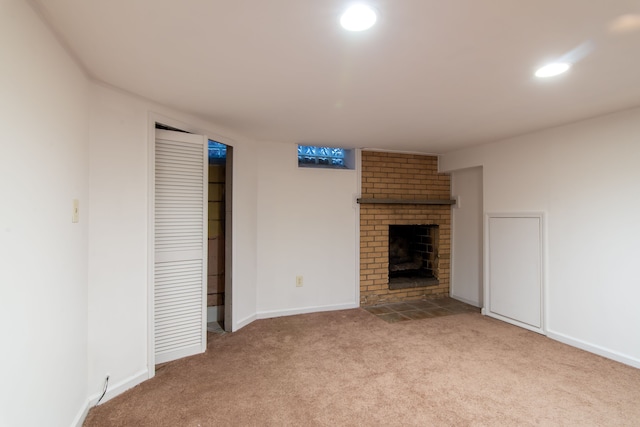 unfurnished living room with light colored carpet and a fireplace