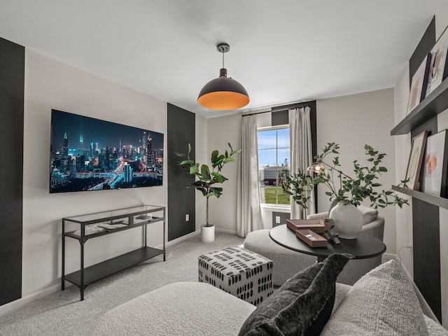 living area featuring carpet floors and baseboards