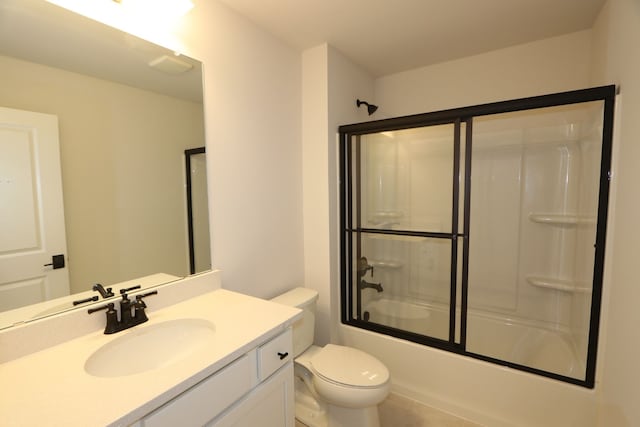 full bath with shower / bath combination with glass door, toilet, tile patterned flooring, and vanity