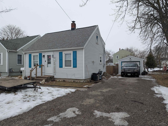 view of front of house with a garage and an outdoor structure