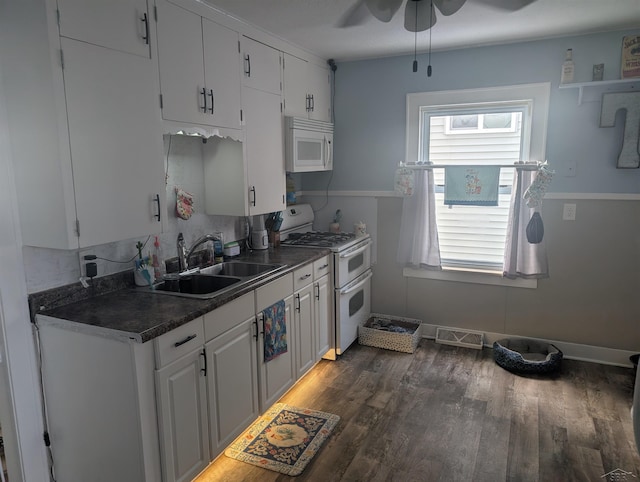 kitchen featuring dark hardwood / wood-style floors, white cabinetry, sink, ceiling fan, and white appliances