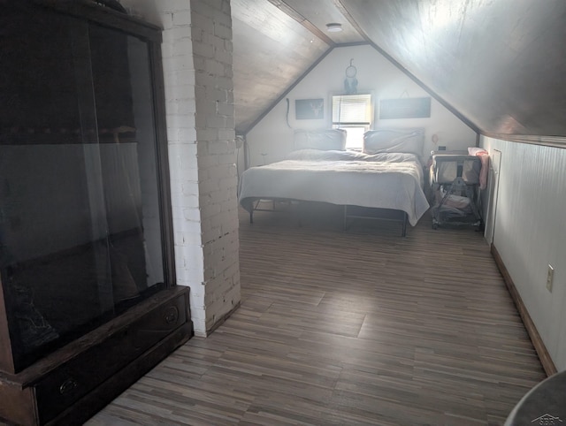 bedroom featuring vaulted ceiling and hardwood / wood-style floors