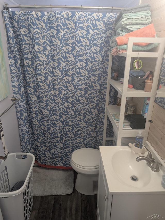 bathroom featuring vanity, hardwood / wood-style floors, and toilet