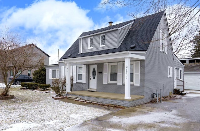 bungalow-style home featuring a porch and a garage