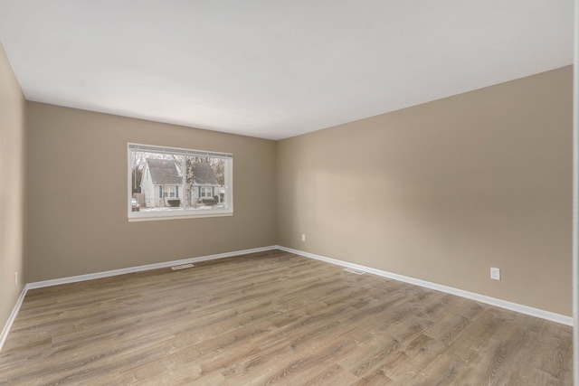 unfurnished room with light wood-type flooring