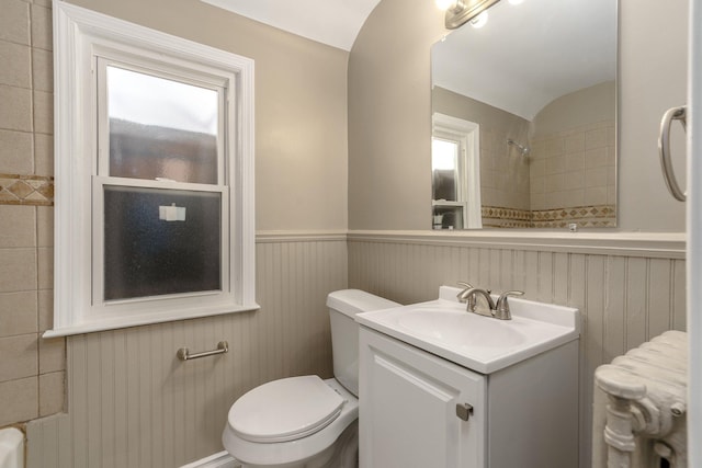 bathroom with vanity, toilet, radiator, and vaulted ceiling