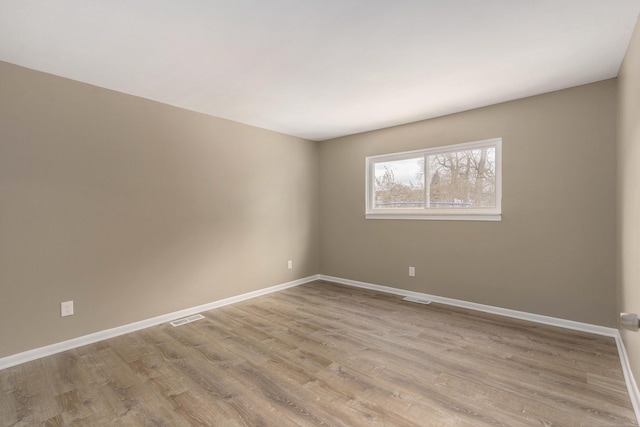 spare room featuring light wood-type flooring