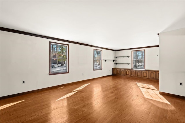 unfurnished living room with crown molding and light hardwood / wood-style floors