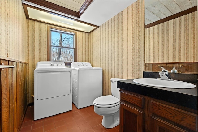 washroom featuring separate washer and dryer, sink, and tile patterned floors