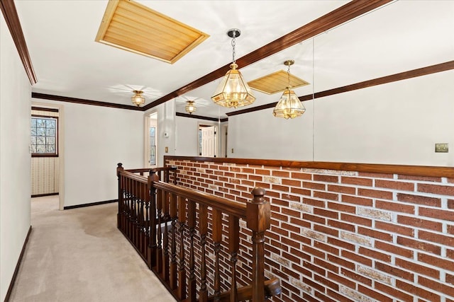 corridor featuring ornamental molding and light carpet