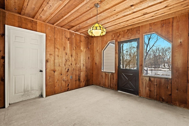 empty room featuring wooden ceiling and wooden walls