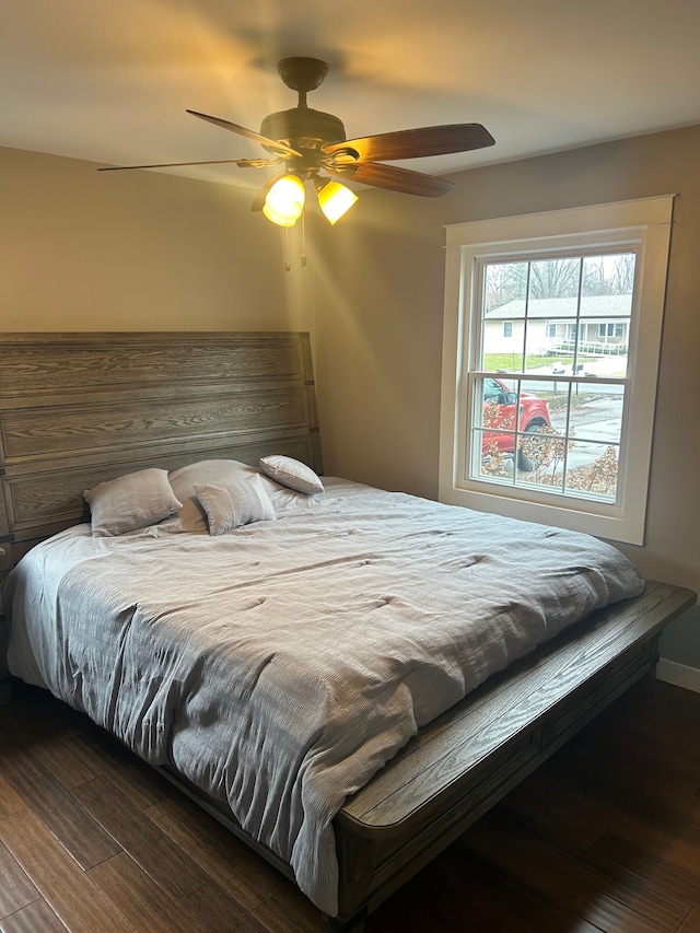 bedroom with dark wood-type flooring and ceiling fan