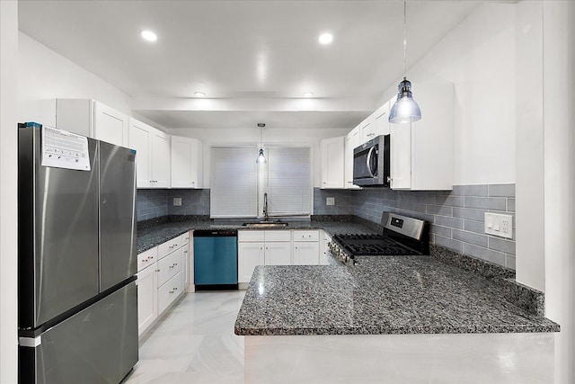 kitchen with appliances with stainless steel finishes, kitchen peninsula, sink, and hanging light fixtures