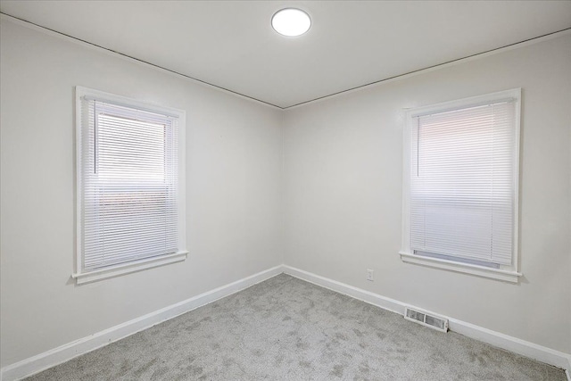 unfurnished room featuring light colored carpet