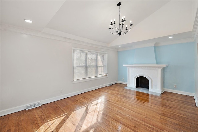 unfurnished living room featuring crown molding, a chandelier, vaulted ceiling, and light hardwood / wood-style flooring